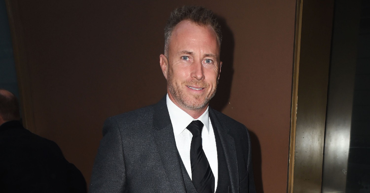 James Jordan in a suit, smiling 