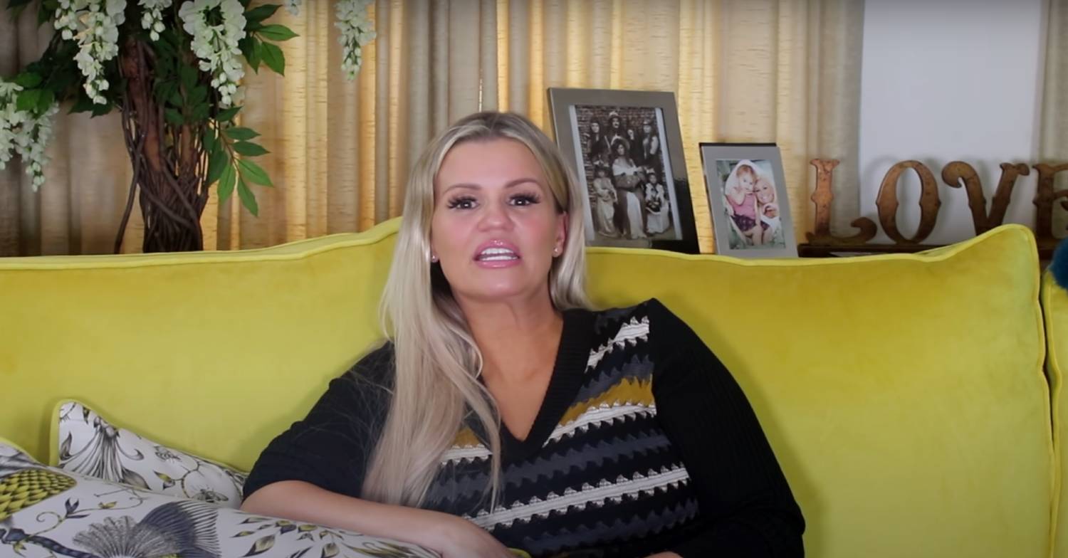 Kerry Katona sits on a sofa