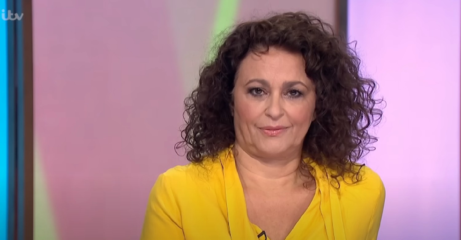 Nadia Sawalha looking at camera in yellow top on Loose Women