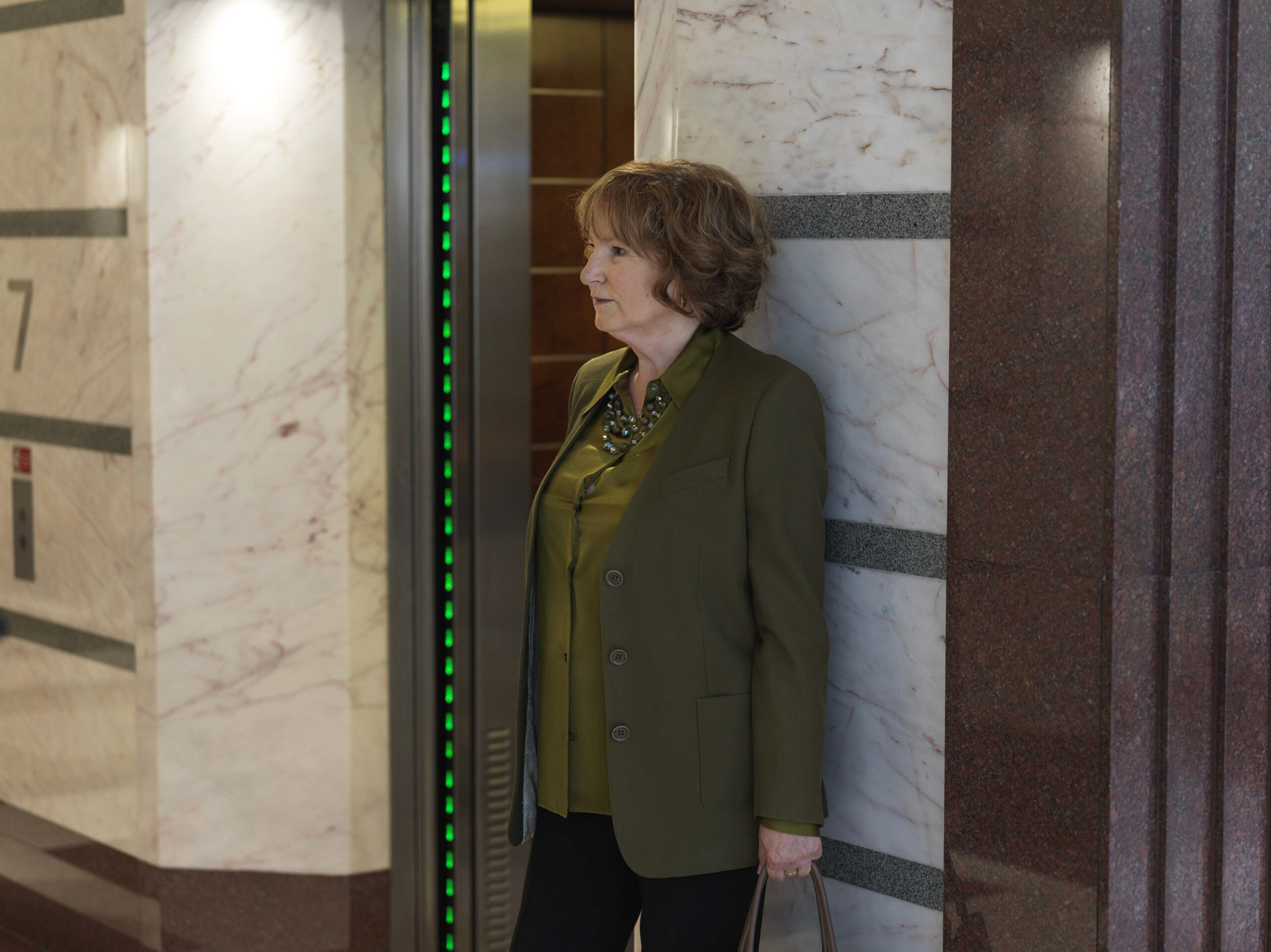 Ruth from The Split season 3 looking contemplative as she poses against a door