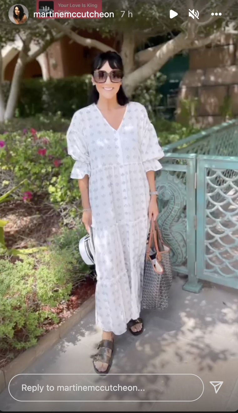 Martine McCutcheon smiling in a white dress on holiday