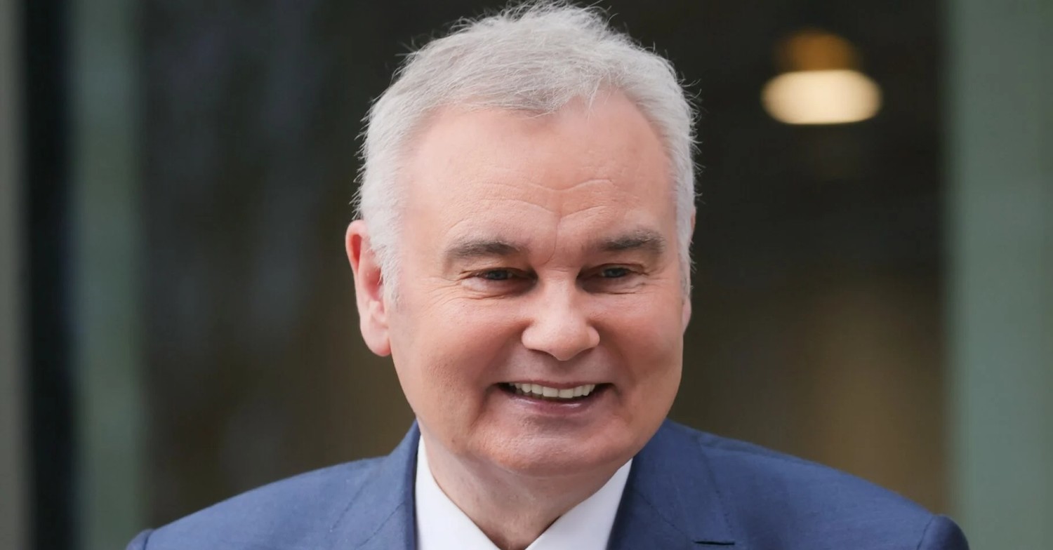 Eamonn Holmes smiling whilst wearing a suit