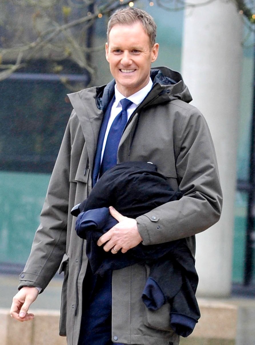 BBC Breakfast presenter Dan Walker smiles at cameras in coat and suit
