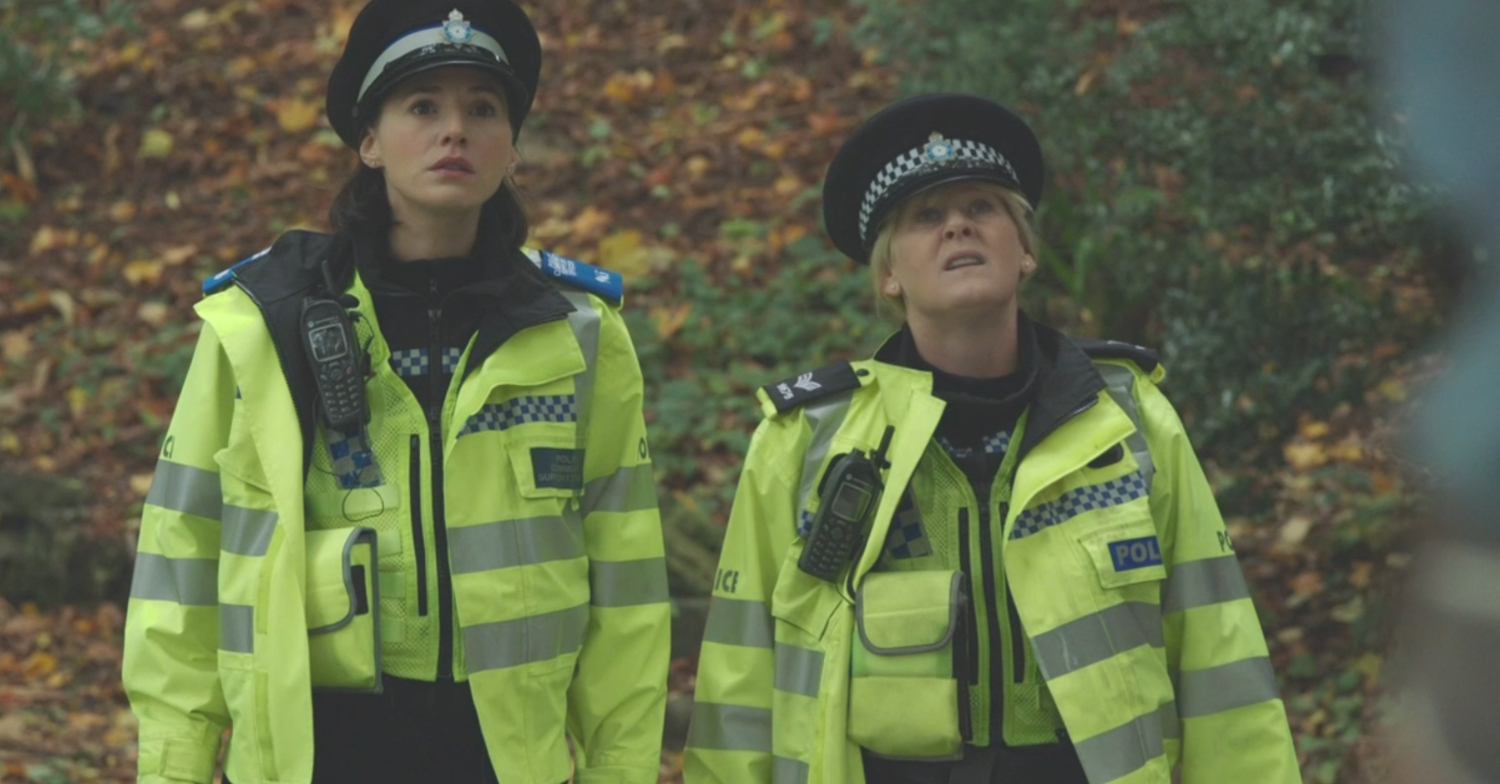 Happy Valley's Charlie Murphy and Sarah Lancashire looking up in the woods