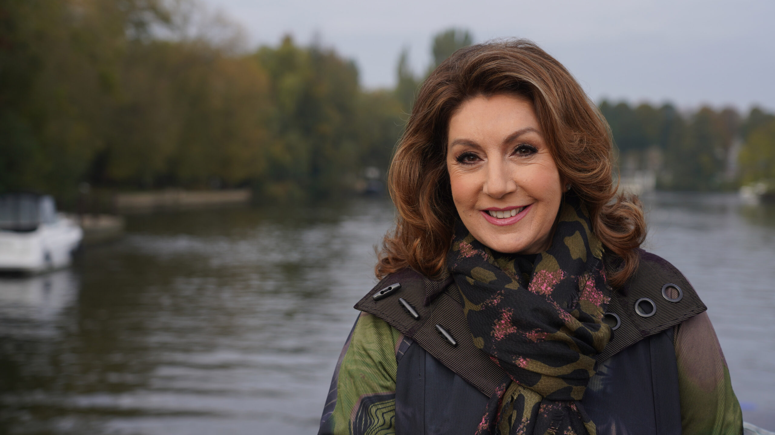 Jane McDonald smiling on a river