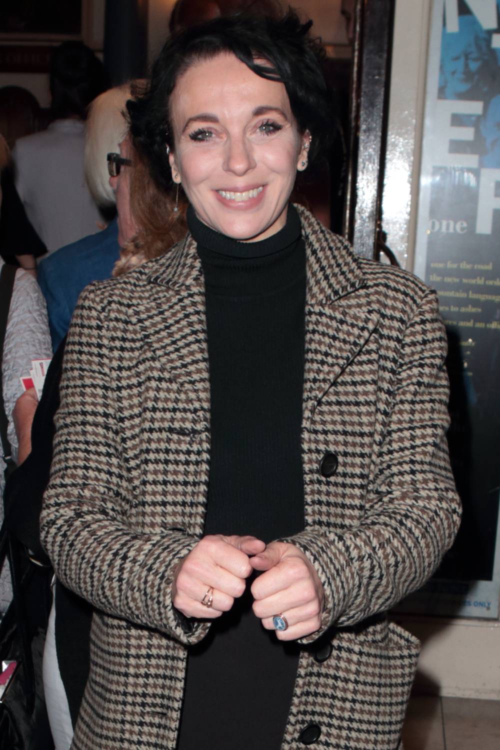 Amanda Abbington with short dark hair smiling for the camera 