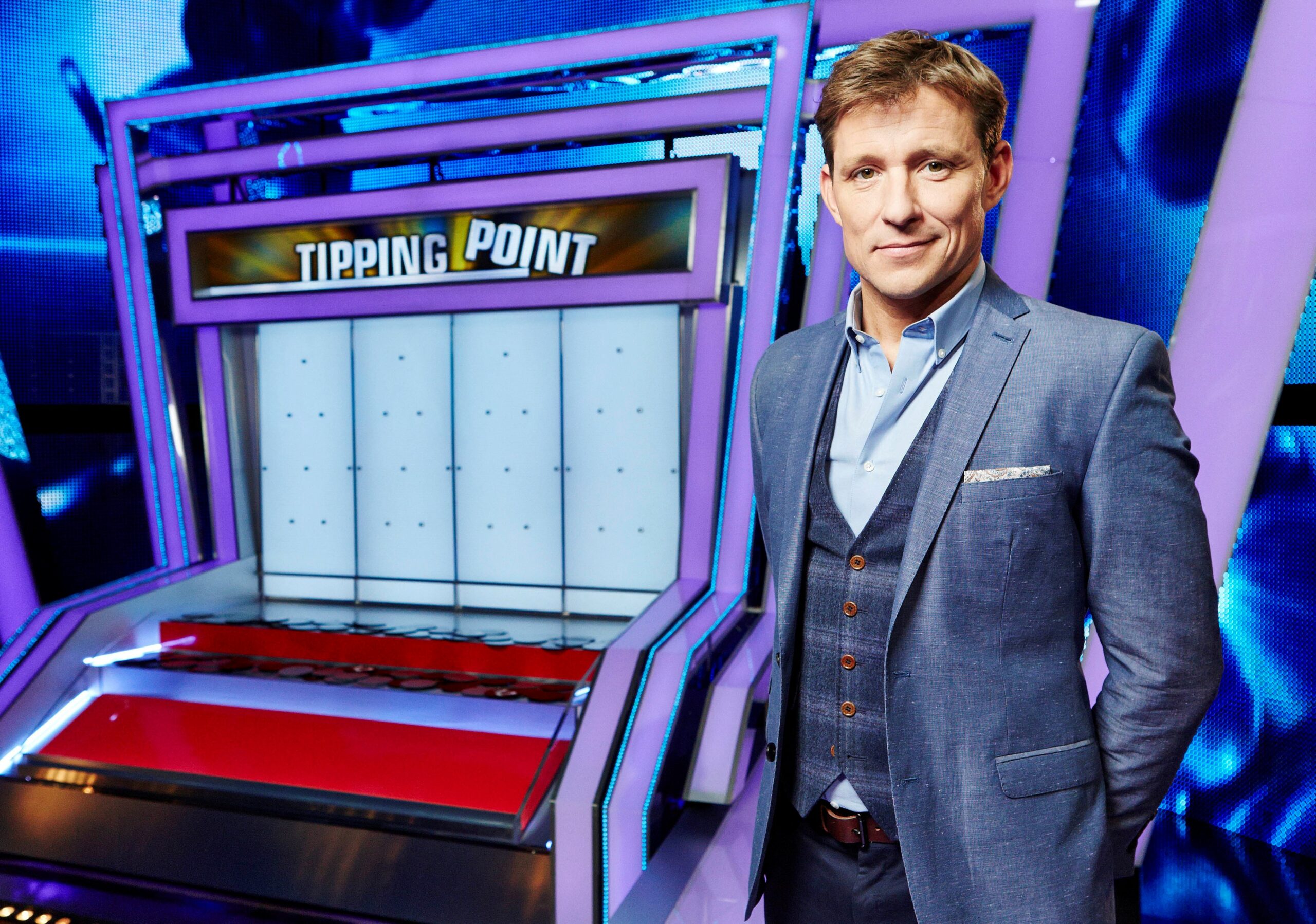 Ben Shephard posing alongside Tipping Point machine in promo shot