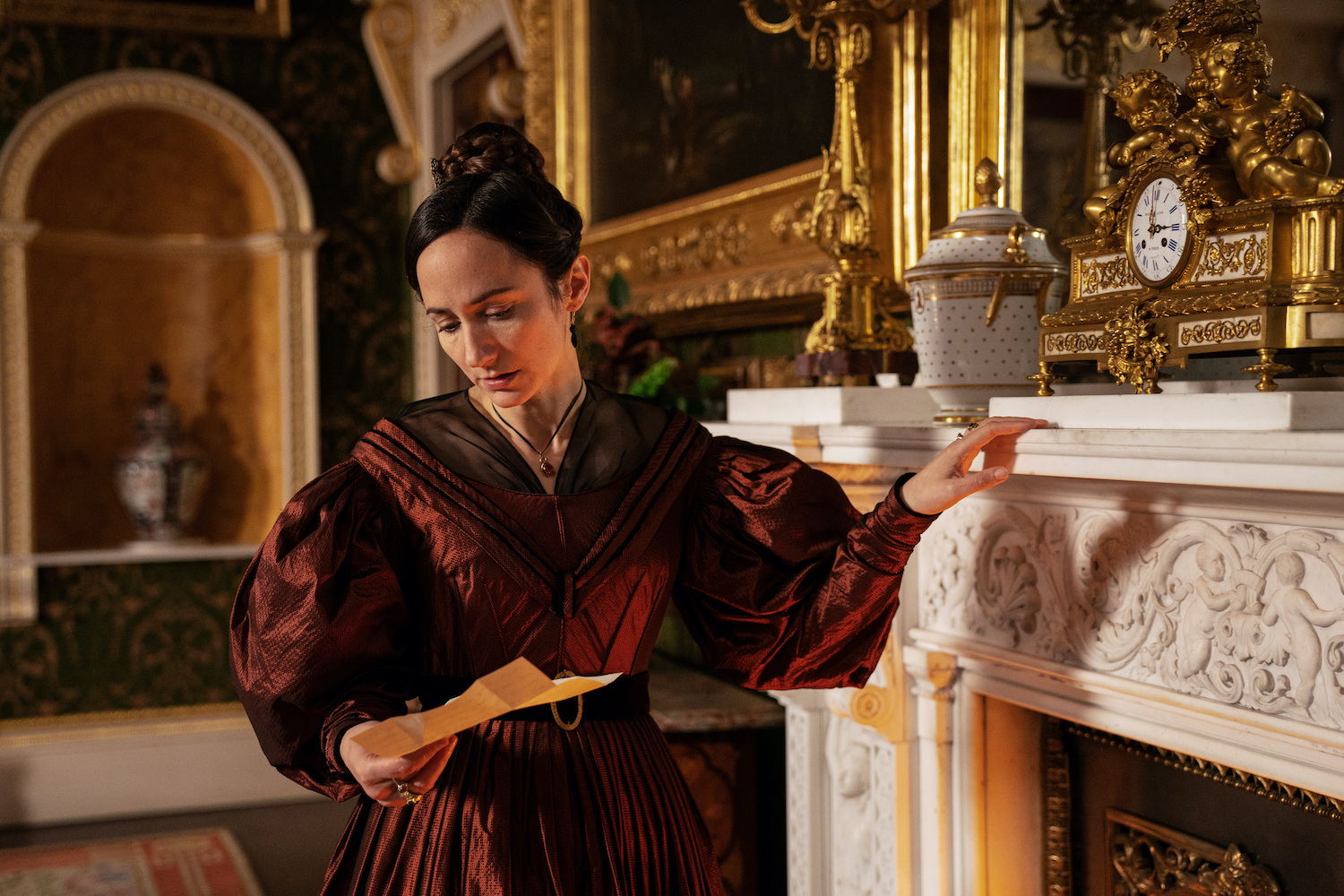 Mariana Lawton posing at a fireplace in Gentleman Jack 