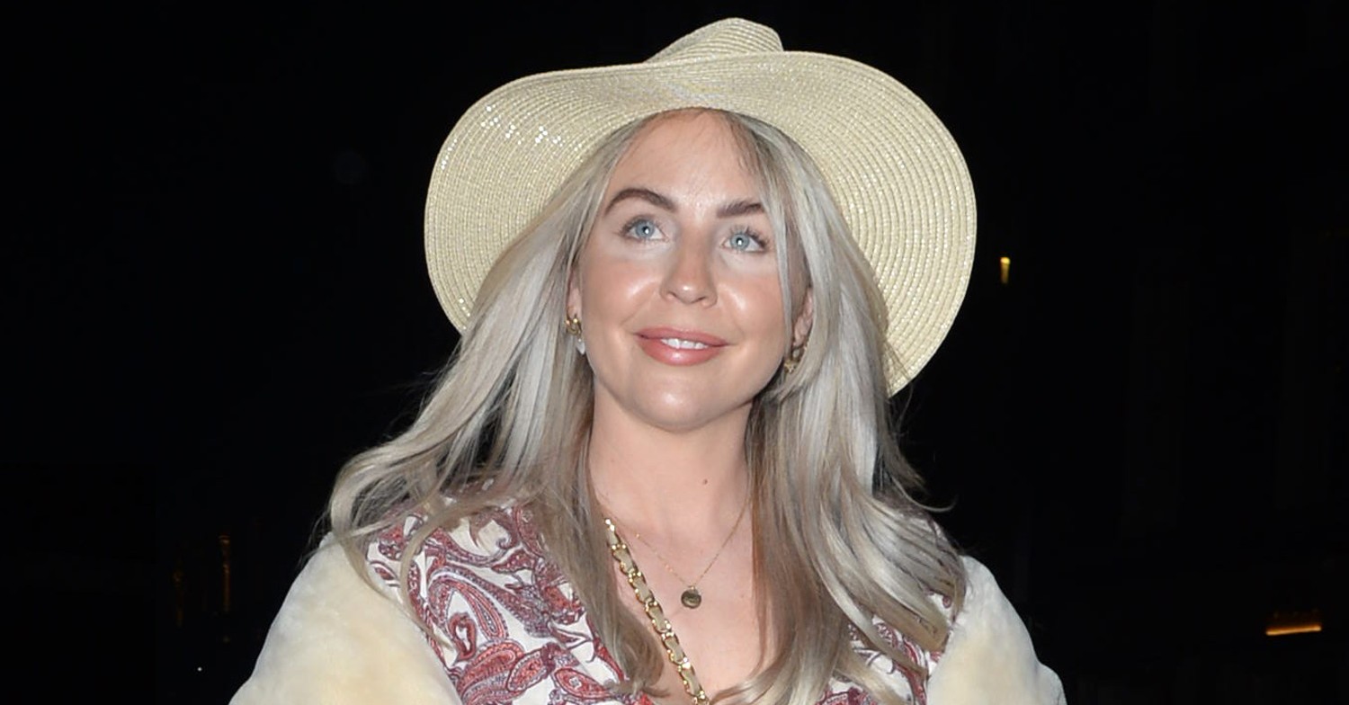 Lydia Bright smiles in hat during night out