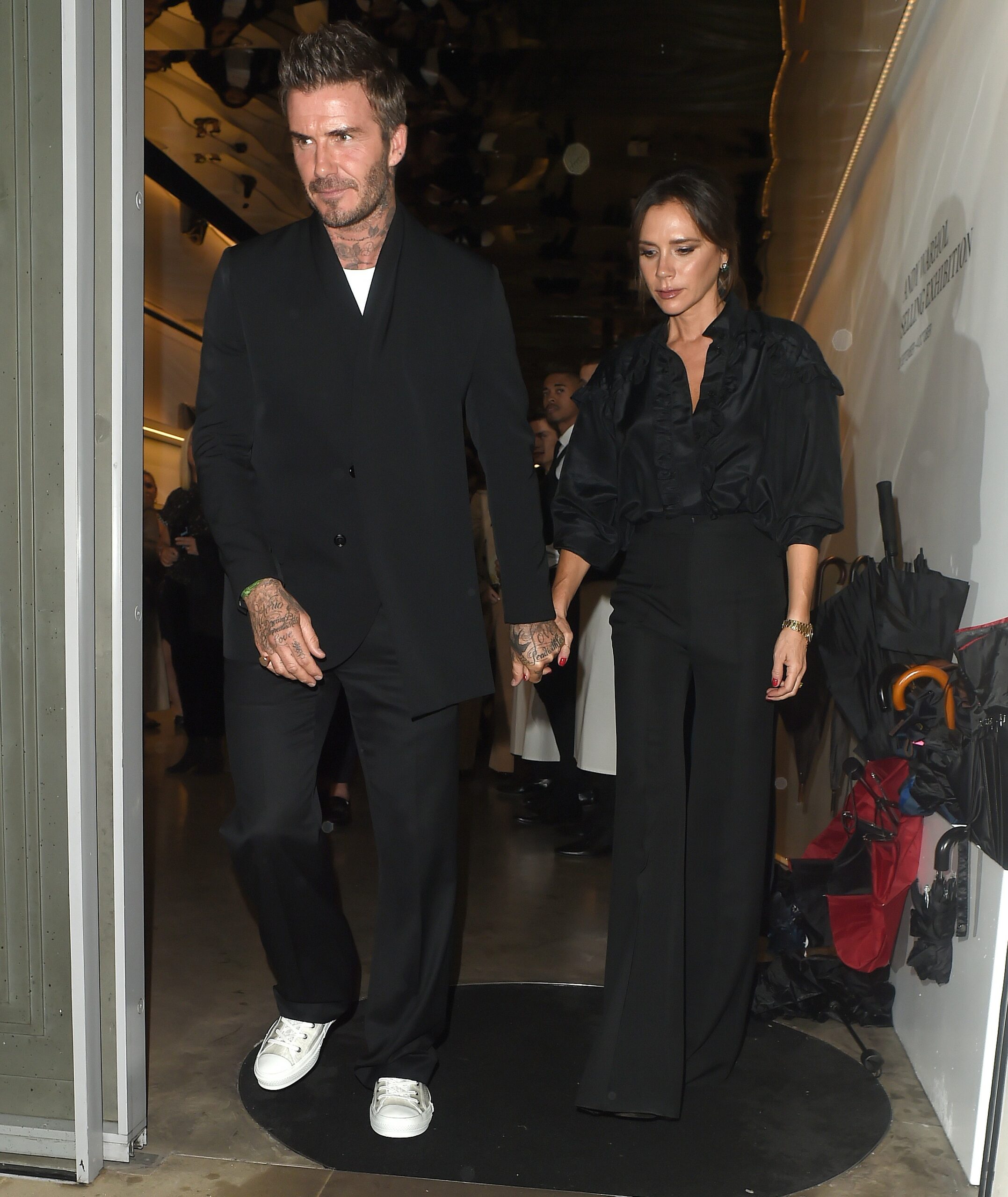 David and Victoria Beckham walking hand in hand during night out