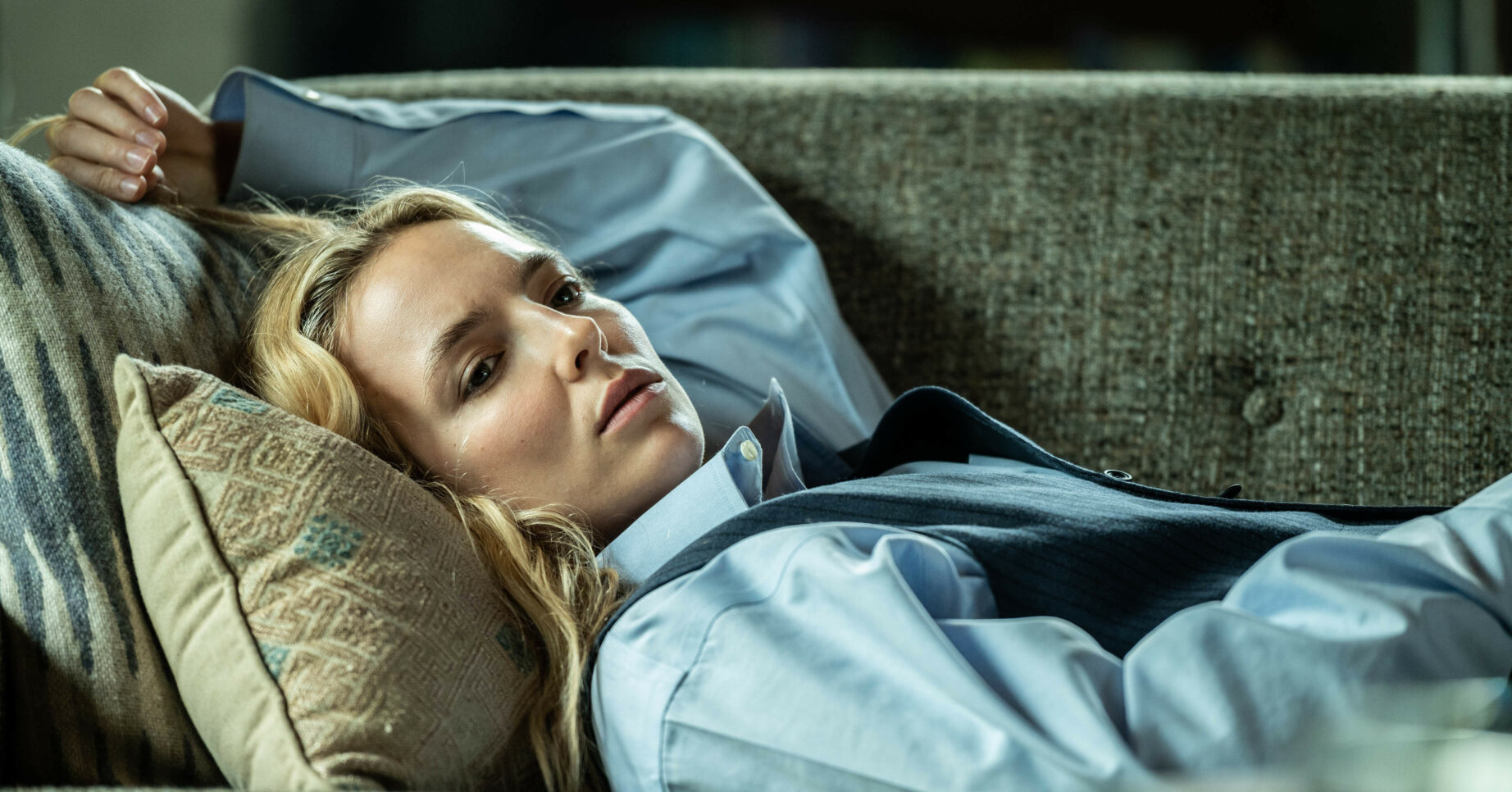 Jodie Comer reclining on a sofa as Villanelle in Killing Eve