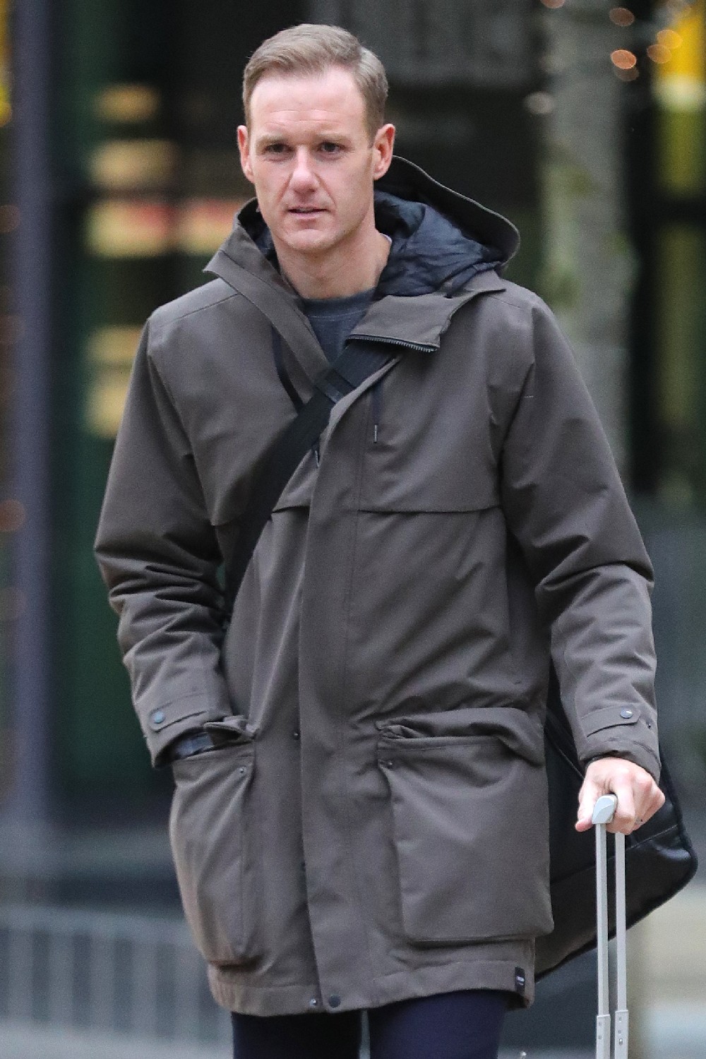 BBC Breakfast presenter Dan Walker wheeling suitcase outside TV studios