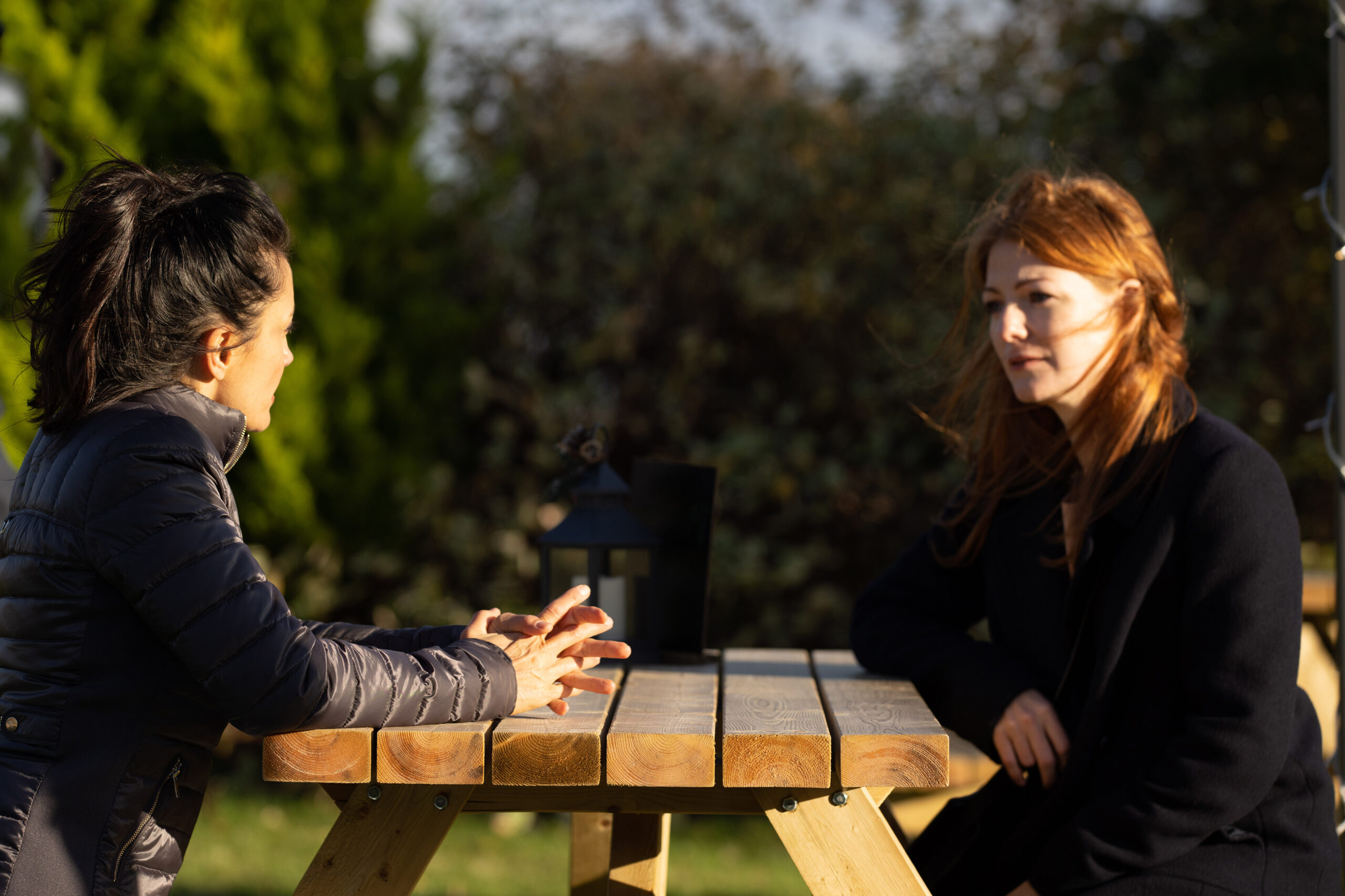Manpreet and Nadine's sister Carol sat at a bench