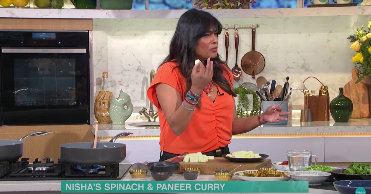 Nisha Katona explains to Josie Gibson what paneer is while holding a cube