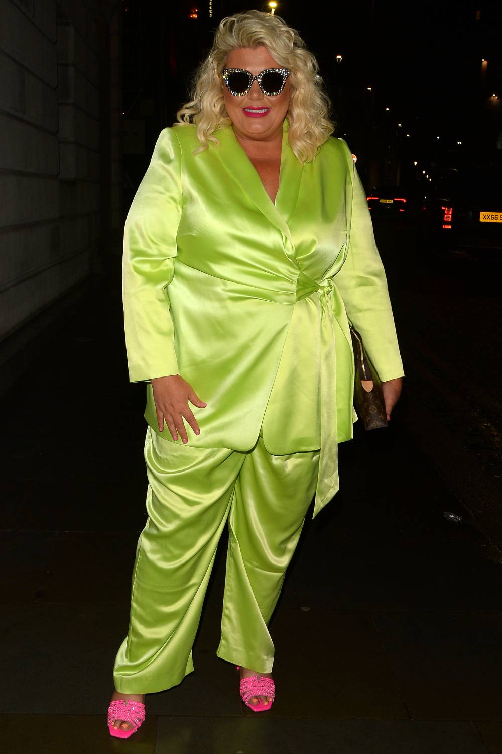 Gemma Collins poses for photographers in a green silk suit