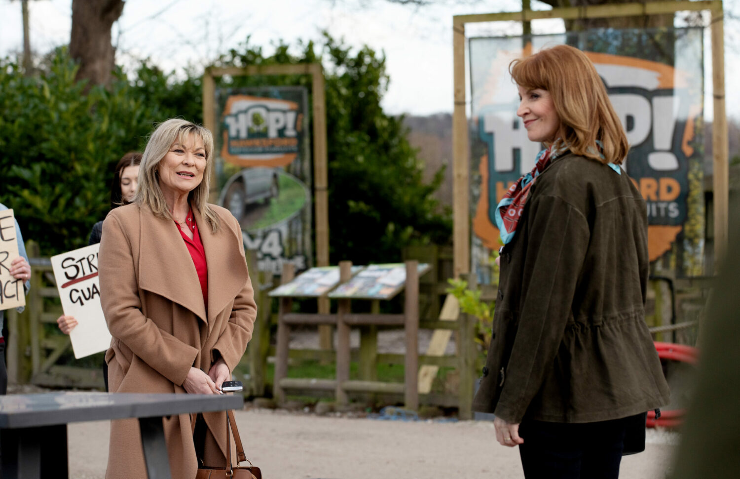 Kim Tate's smile hides her annoyance as she's forced to serve her friend herself