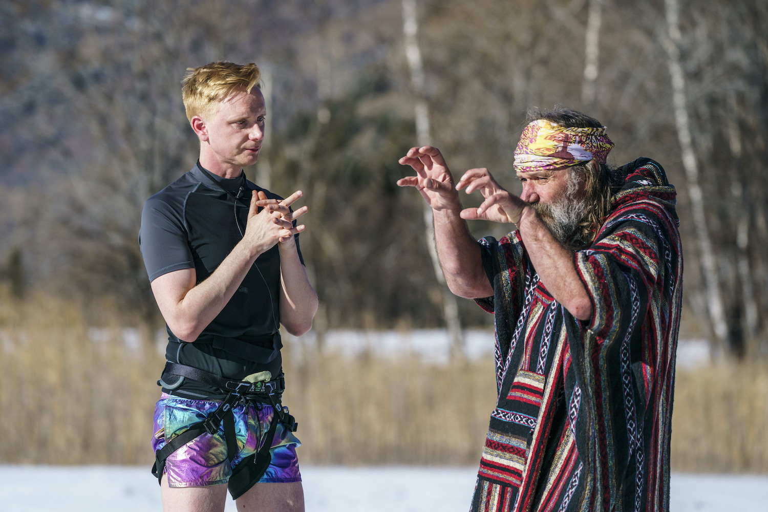 Owain Wyn Evans listening intently to an animated Wim Hof