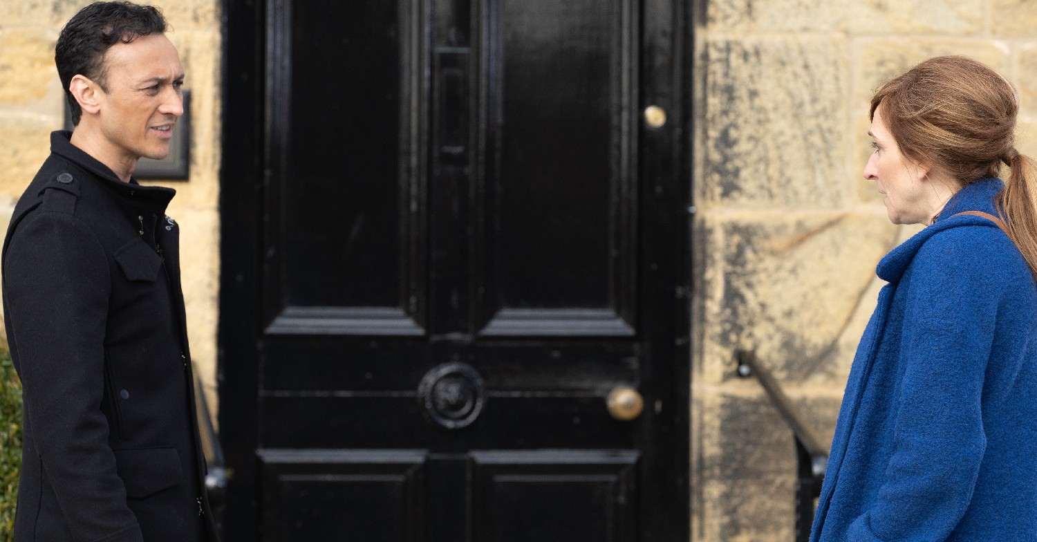 Emmerdale Jai and Laurel in coats outside house talking