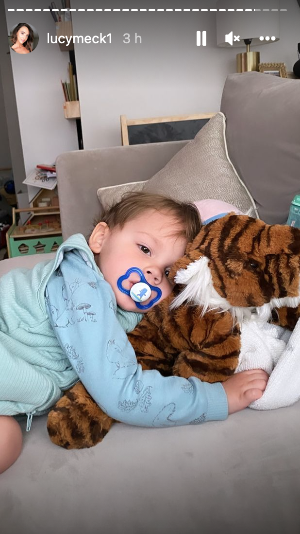 Roman Thomas cuddling his toy tiger