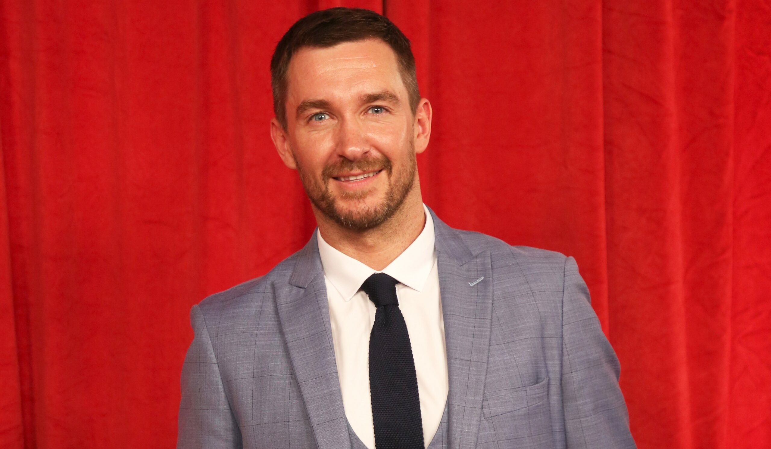 Anthony Quinlan smiles on the red carpet at the British Soap Awards 2019