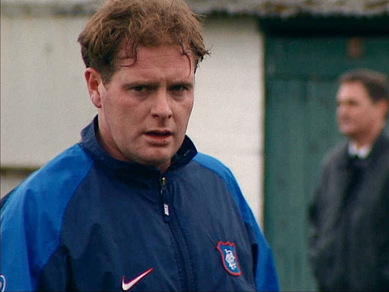 Paul Gascoigne looking worried in a football training top
