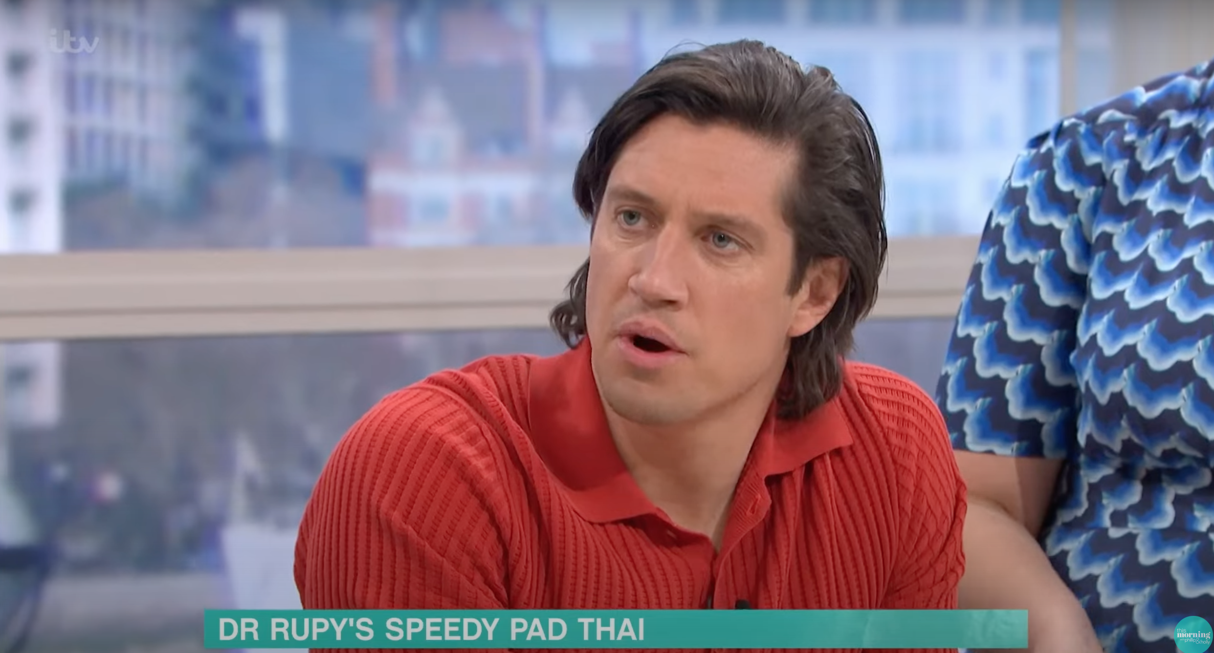 Vernon Kay presenting This Morning in a red top