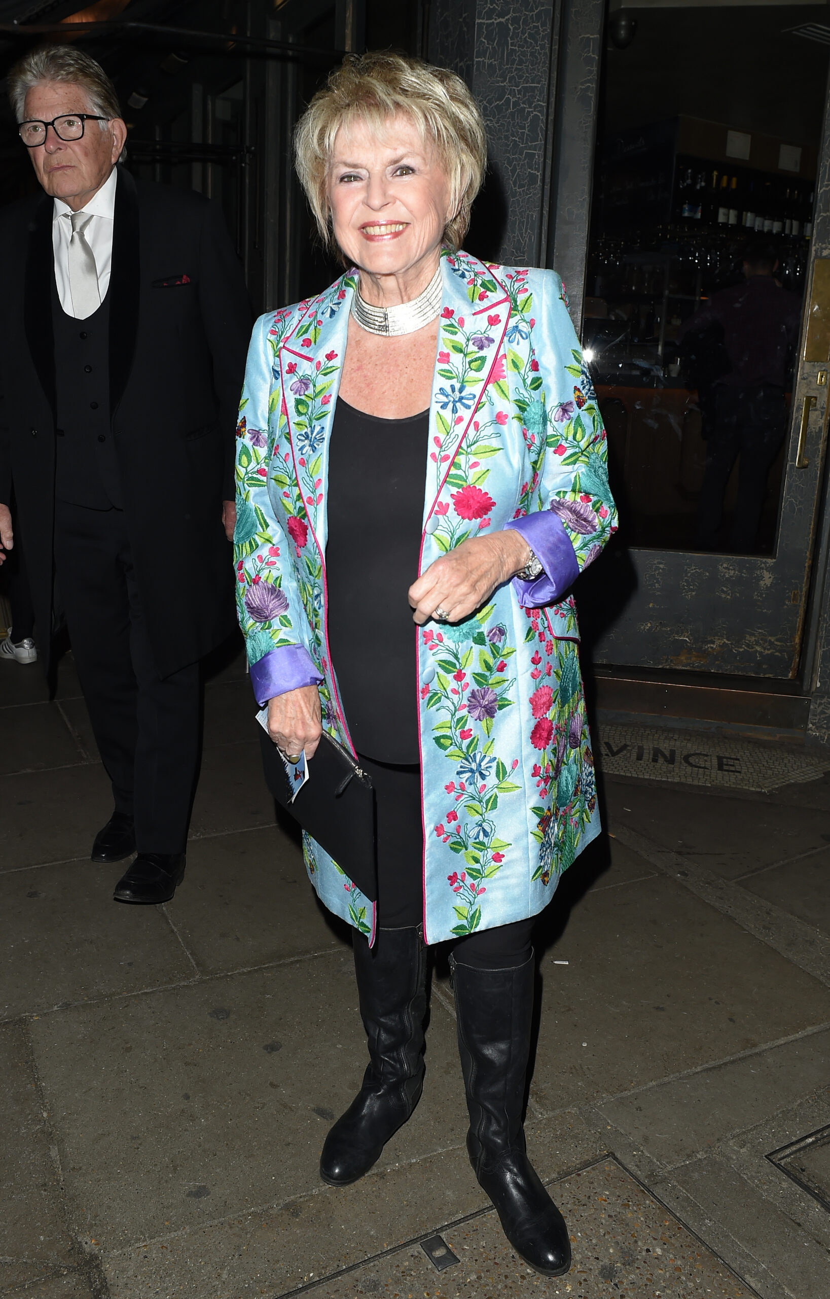 Gloria Hunniford smiling on a night out wearing a multi-coloured jacket