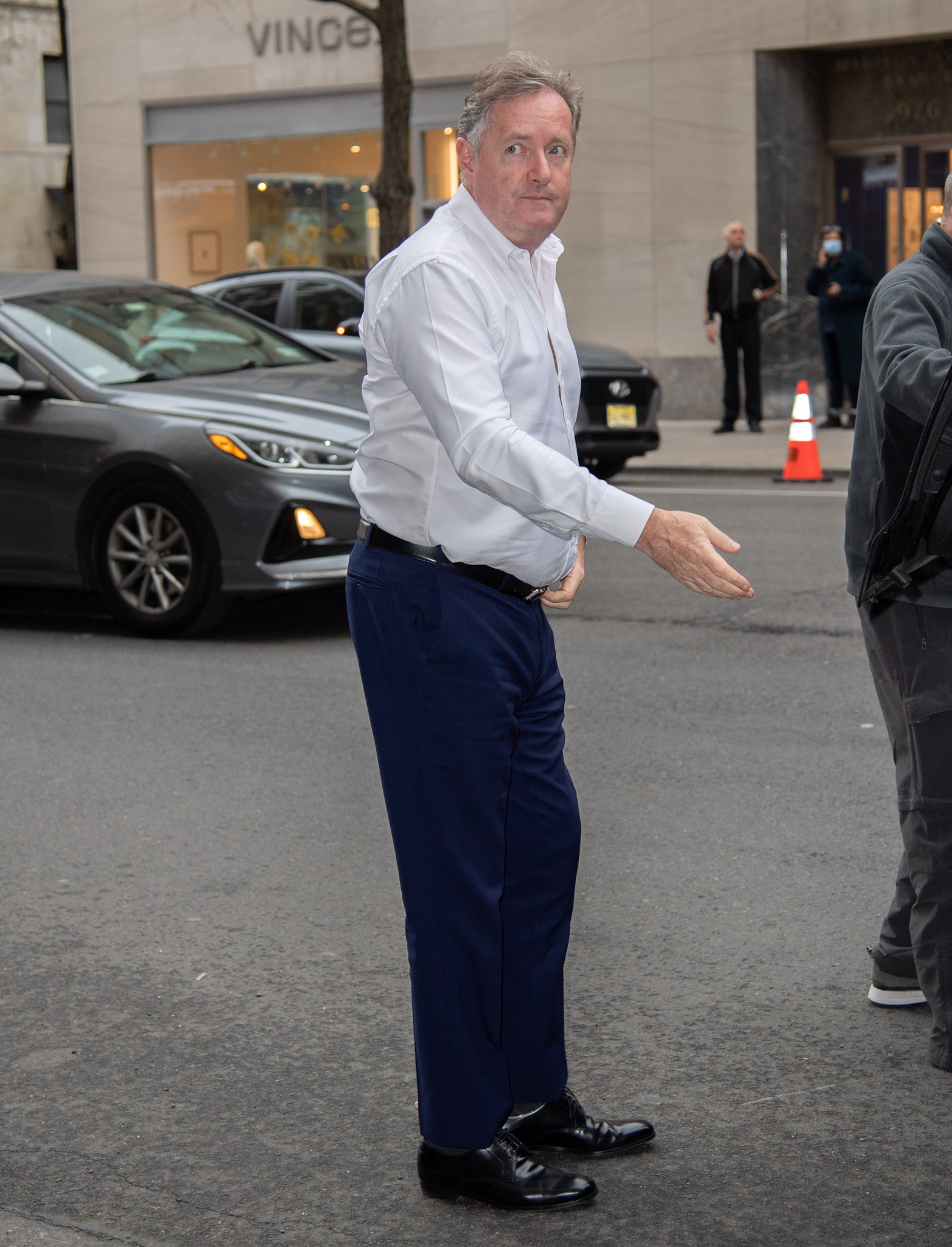 Piers Morgan frowns as he approaches his car