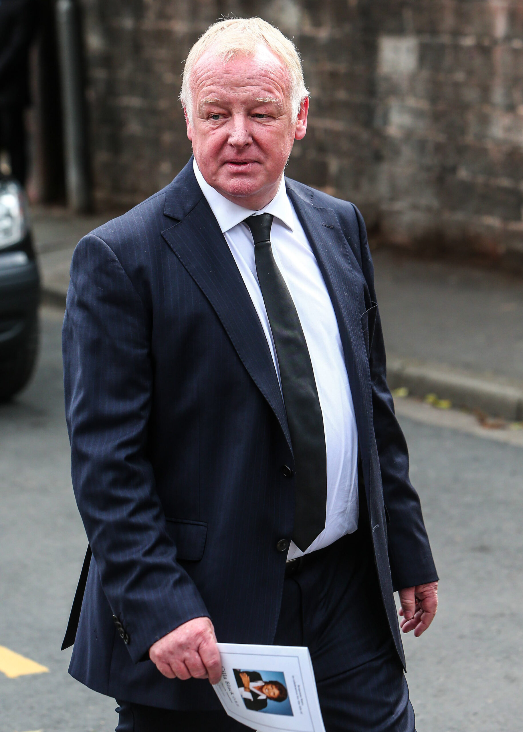 Les Dennis in a black suit