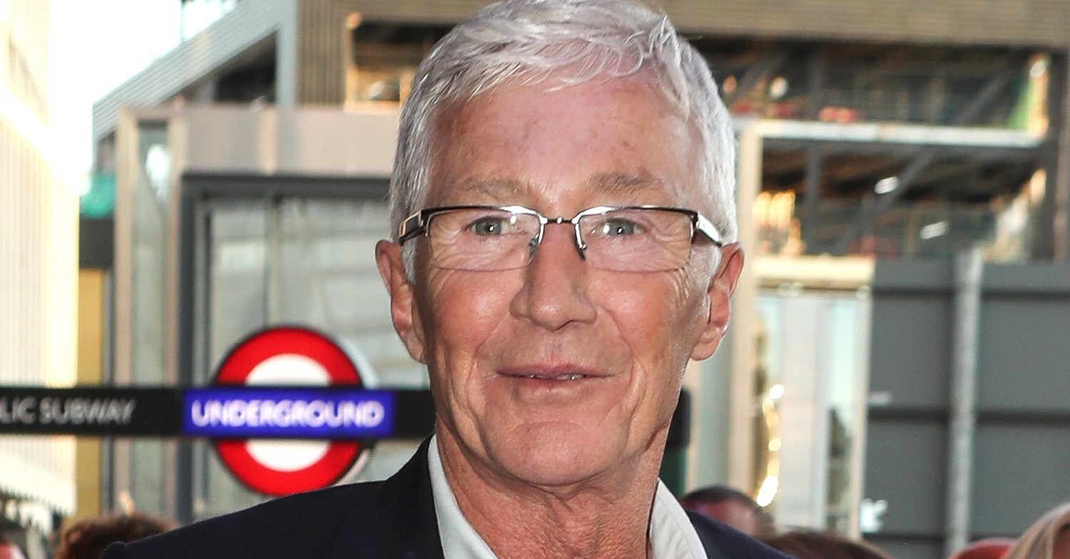 Paul O'Grady smiles for cameras outside London underground