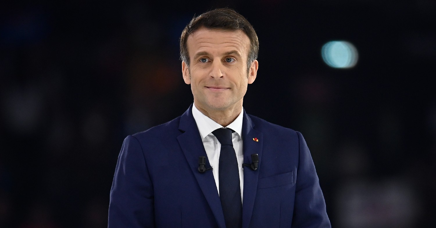President Macron smiling in suit