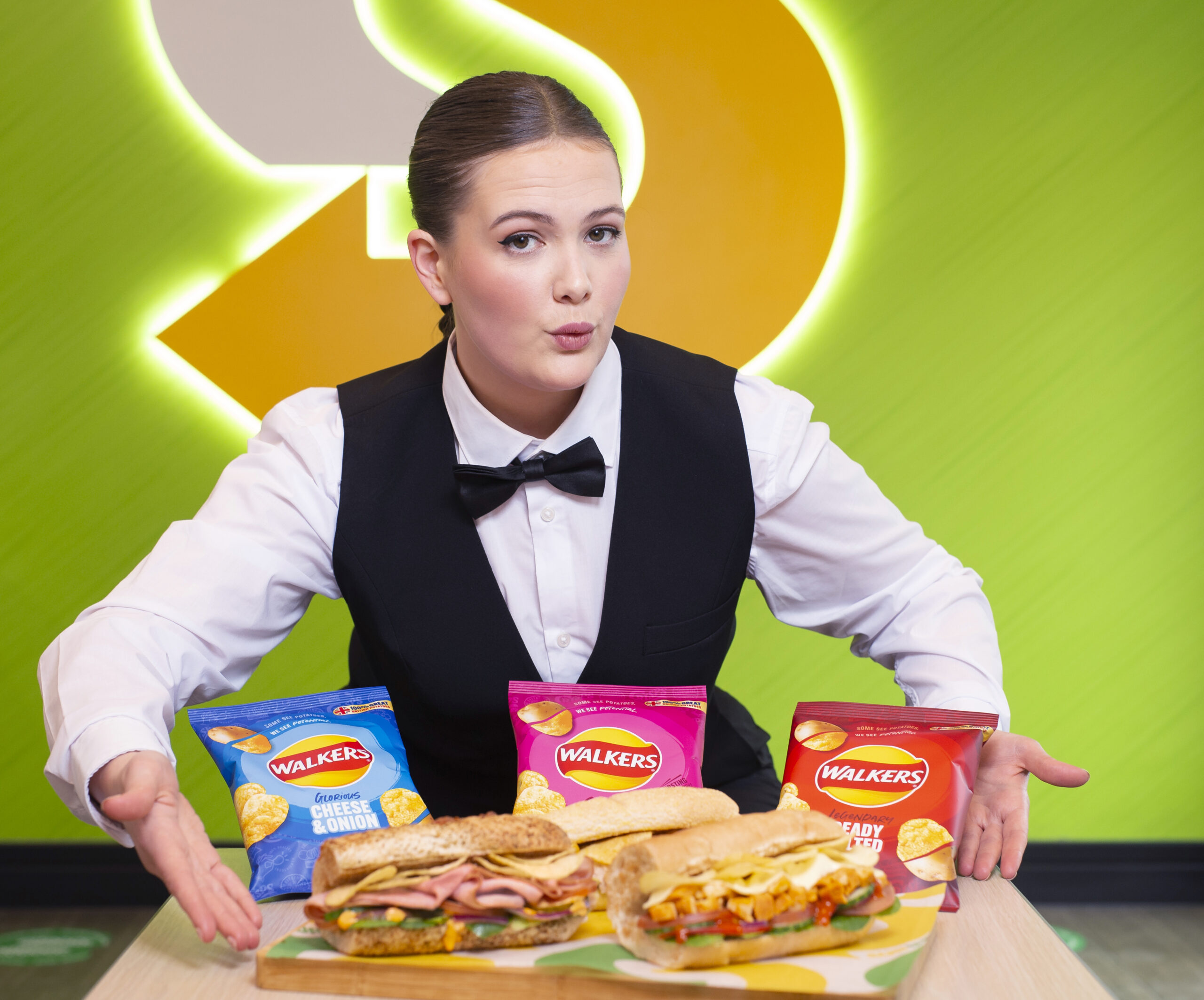 Woman going ohhh holding three sanwiches