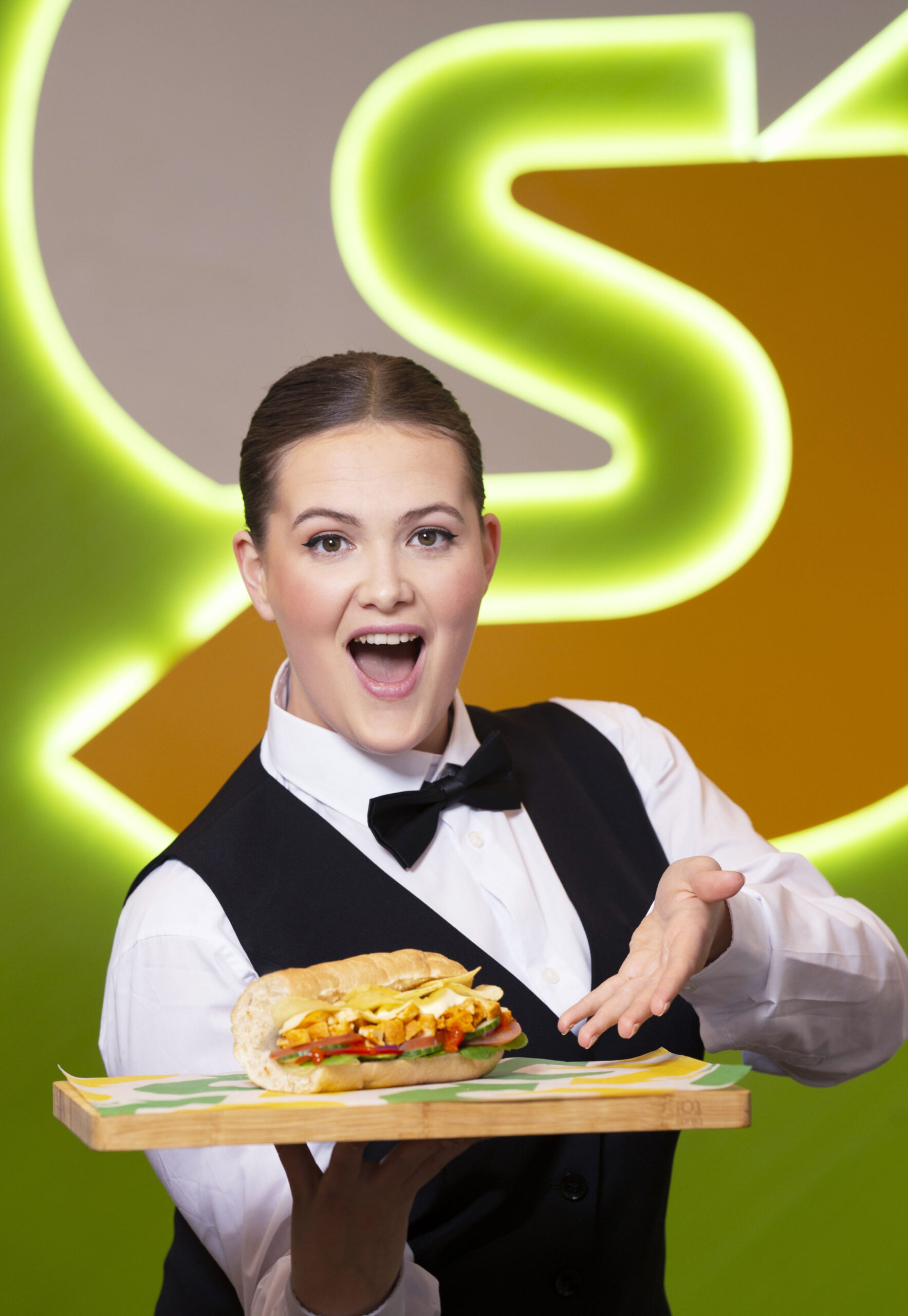 Woman holding a subway sandwich as a lunch idea