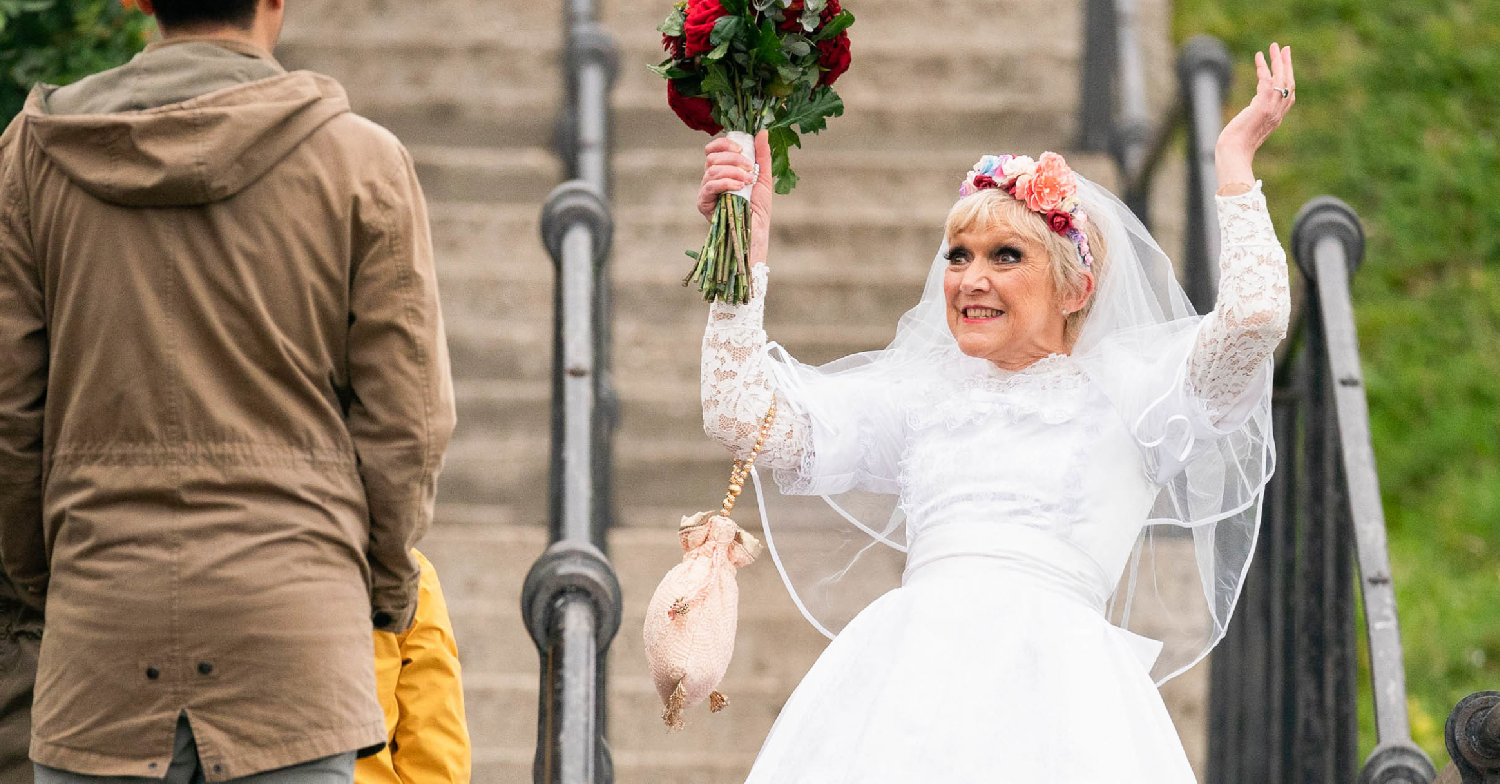 EastEnders Jean throws her arms in the air in wedding dress in Southend