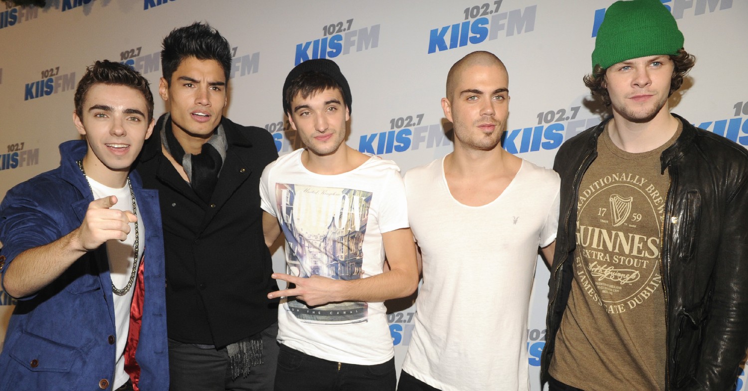 Tom Parker smiling with his The Wanted bandmates at event