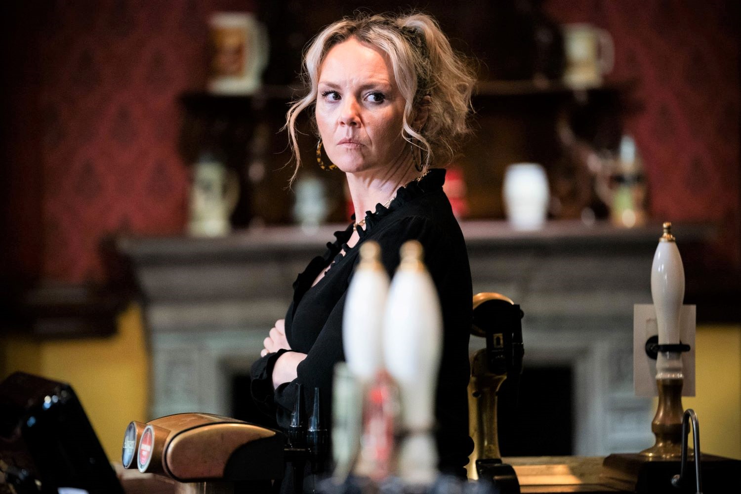 Janine looks worried as she watches Whitney and Mick in EastEnders