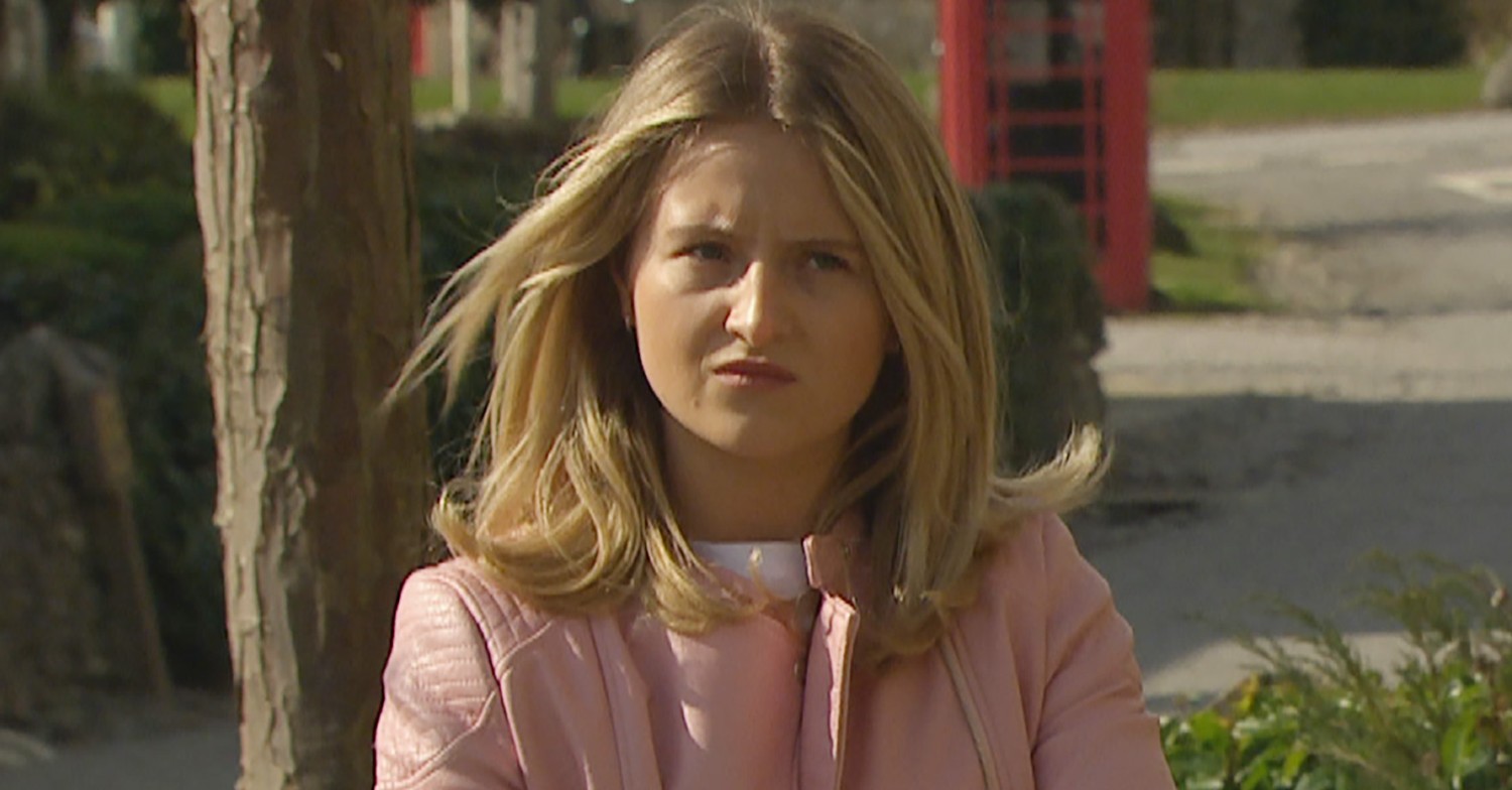 Amelia looking angry in Emmerdale wearing pink