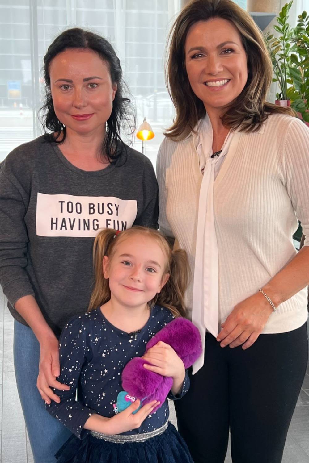 Susanna Reid stands alongside Ukrainian child Amelia and her mum Lilia