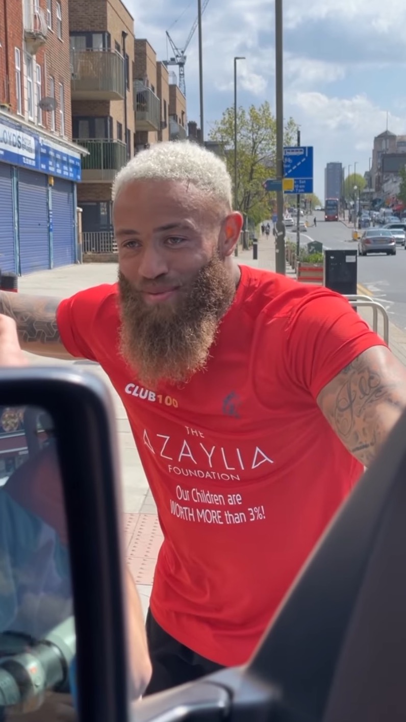 Ashley Cain wearing a red Azaylia T-shirt
