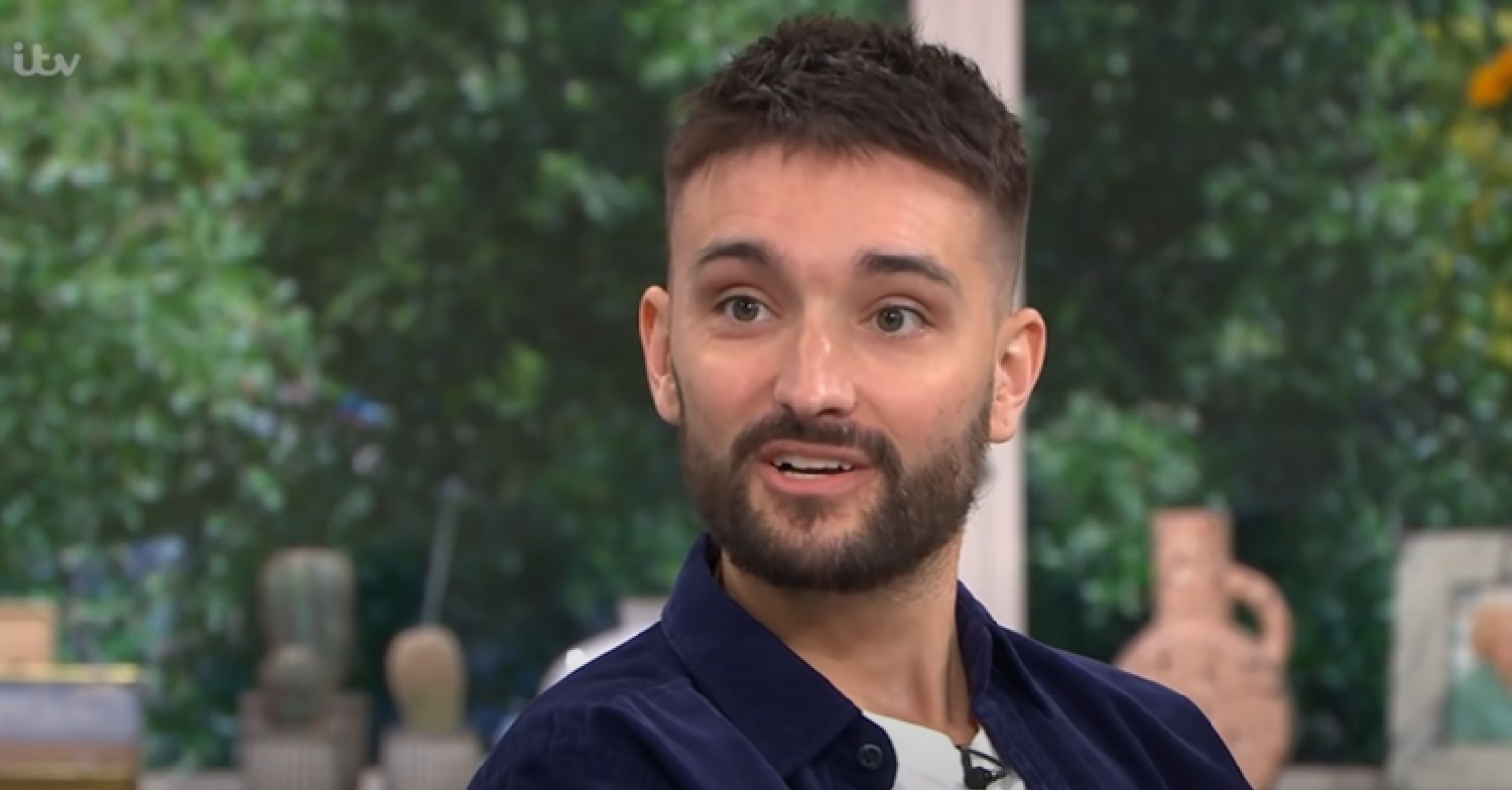 Tom Parker speaking in blue jacket on This Morning in 2021