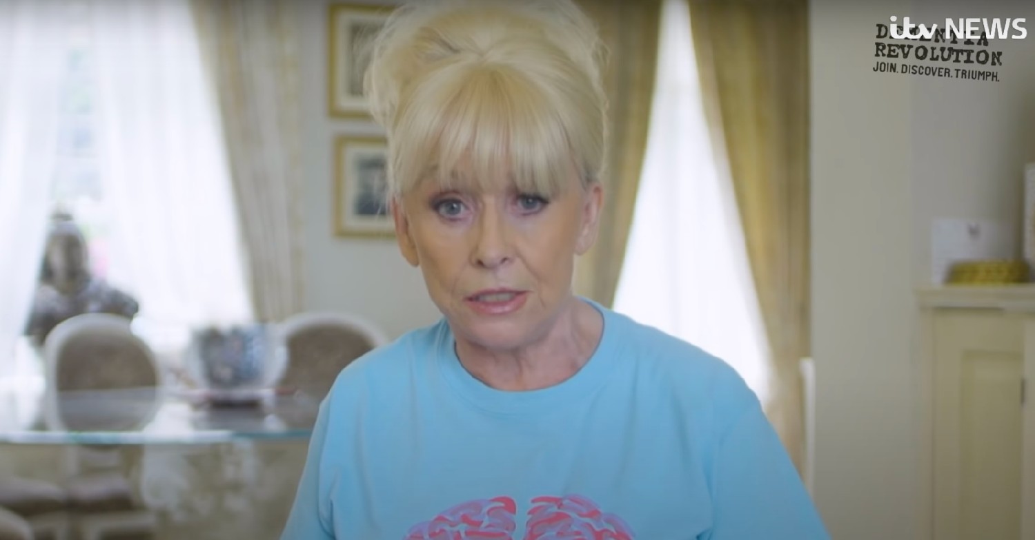 Barbara Windsor talking to camera in blue shirt