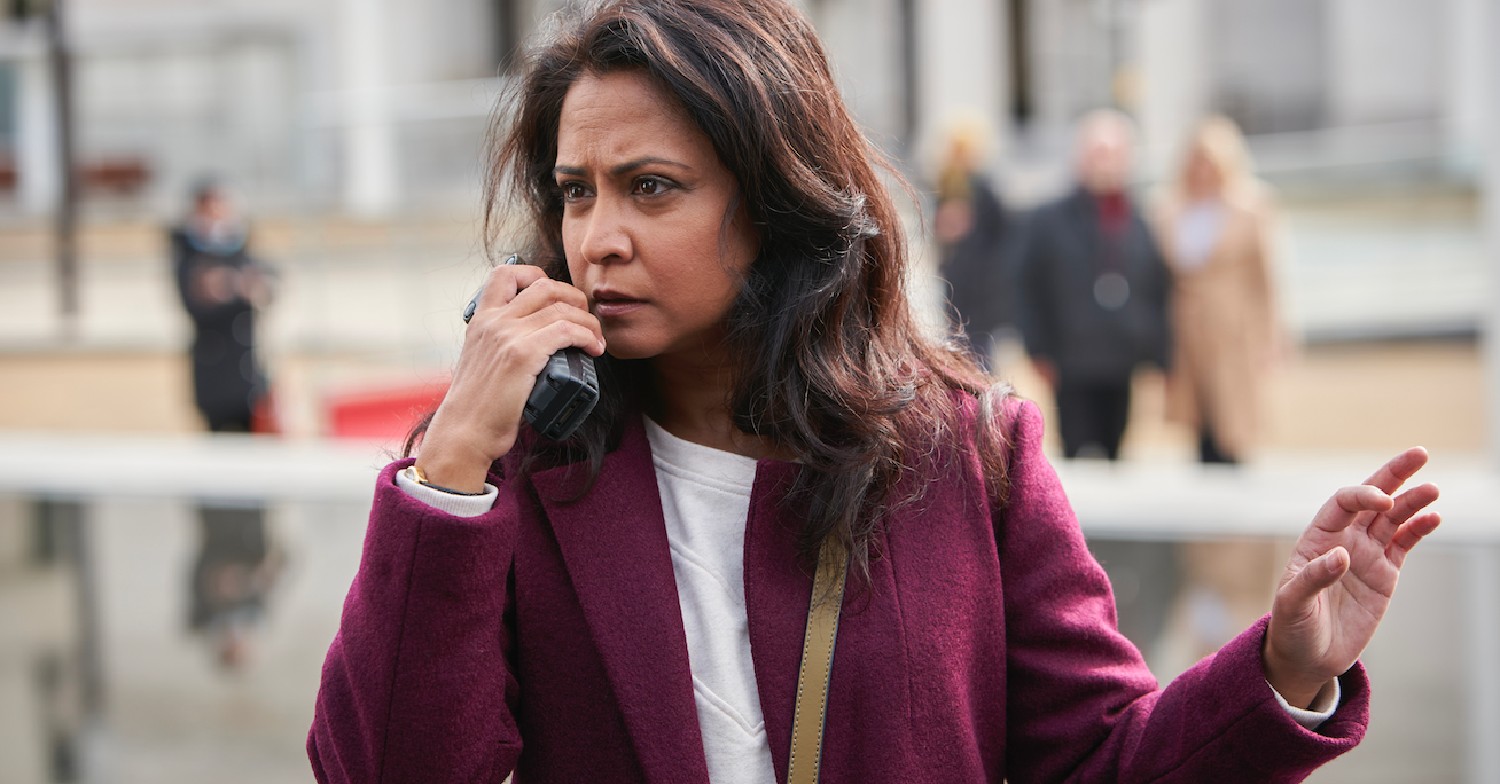 Parminder Nagra as Rachita Ray using walkie talkie outside 