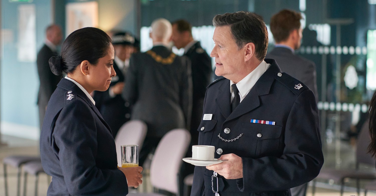 DI Ray and Beardsmore talking in police uniform at an event