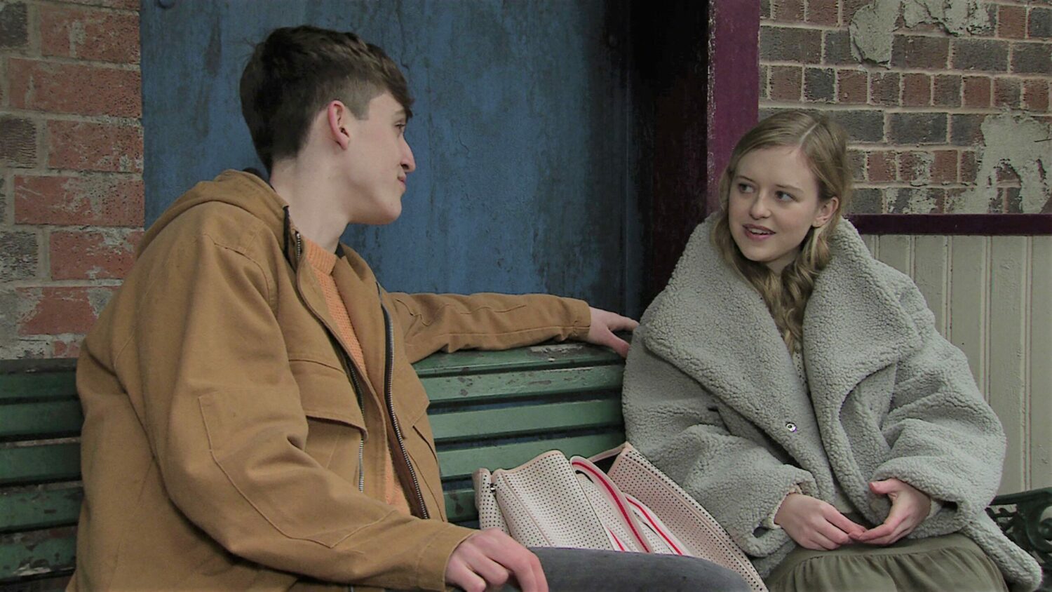 Coronation Street Aaron and Summer talk on a bench in Victoria Garden
