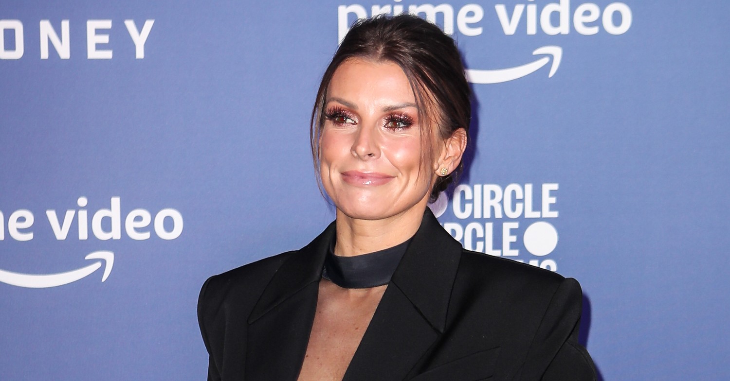 Coleen Rooney smiles in black outfit