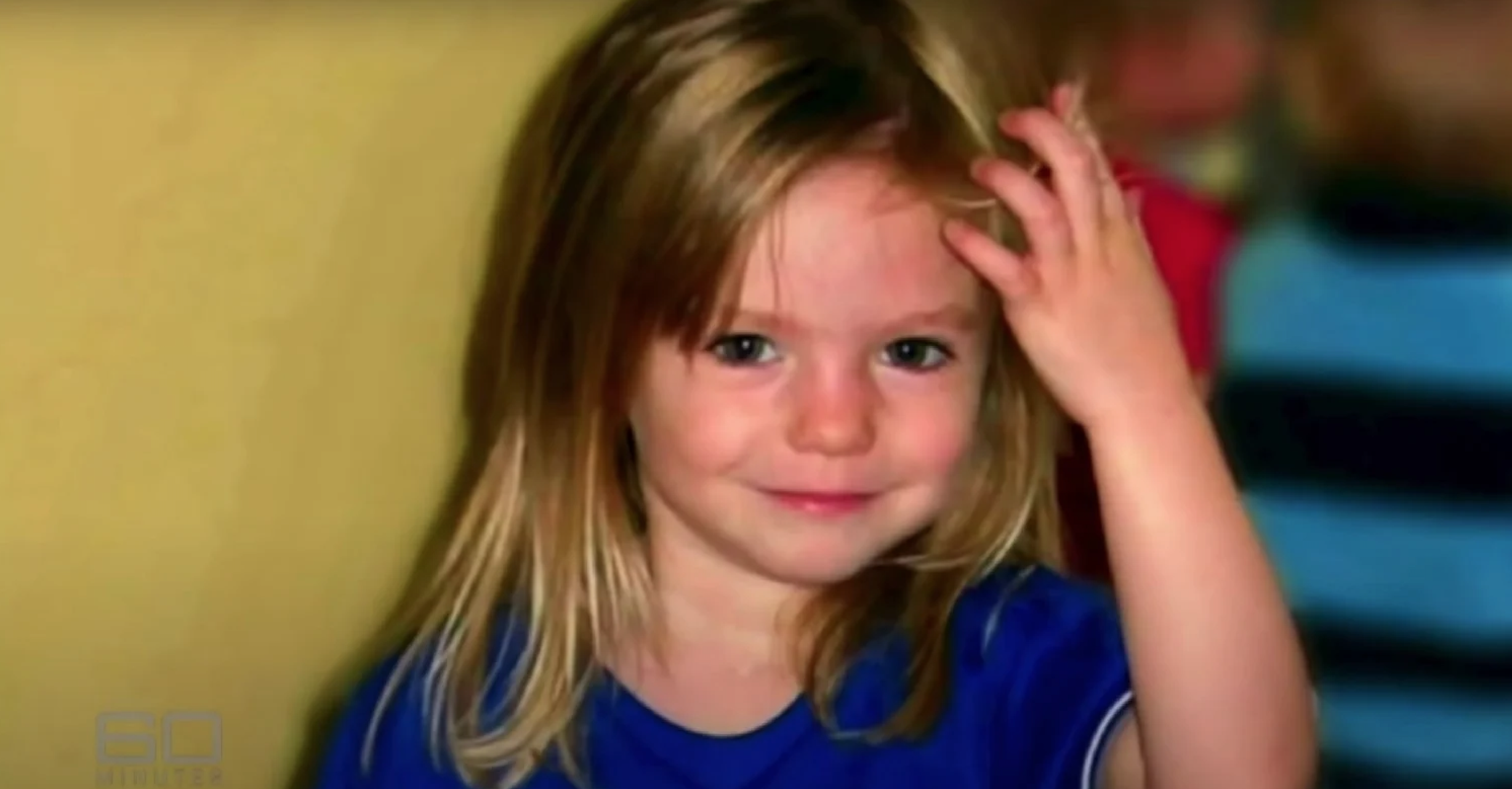 Madeleine McCann smiling wearing a blue top