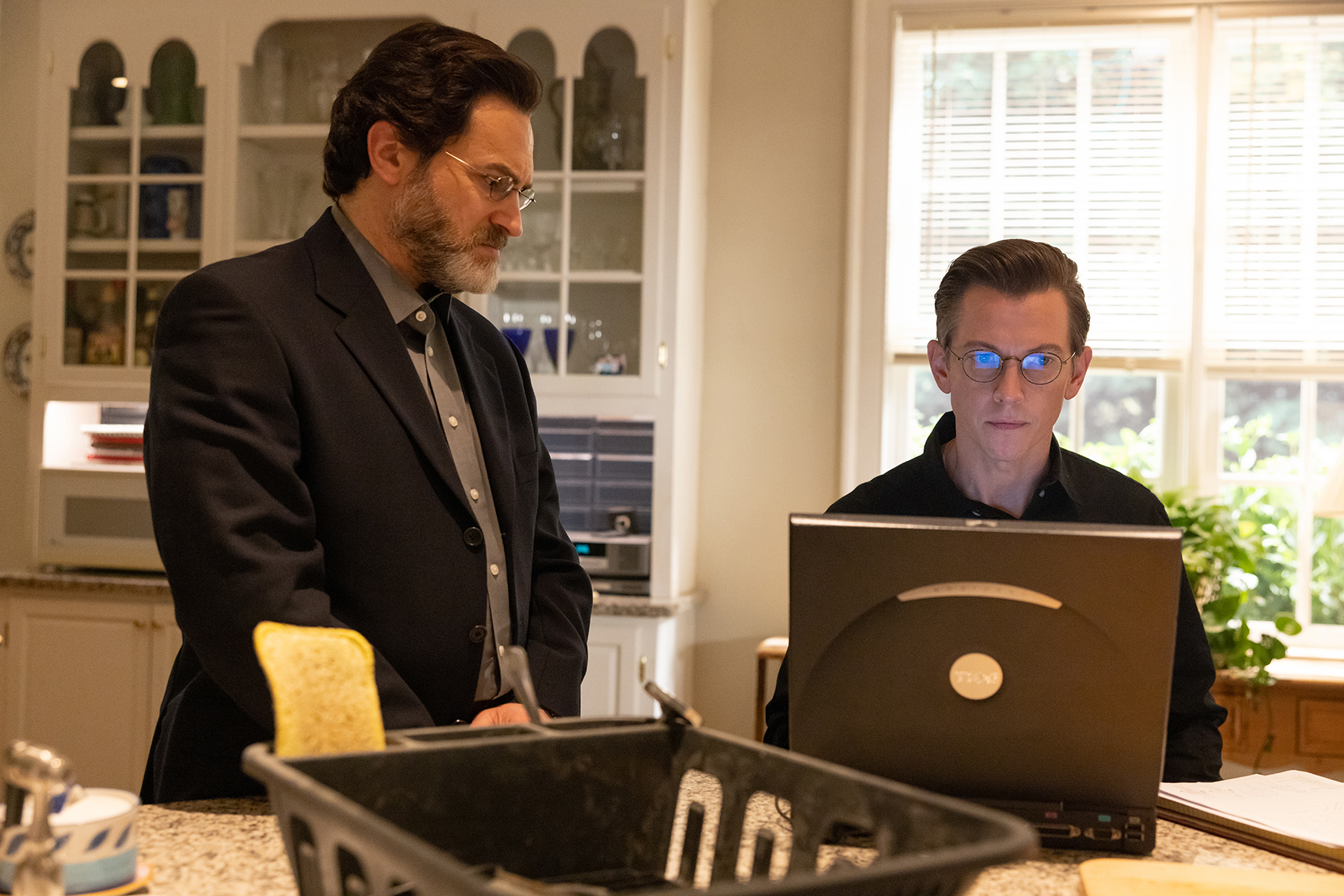 Two men looking at a laptop in The Staircase