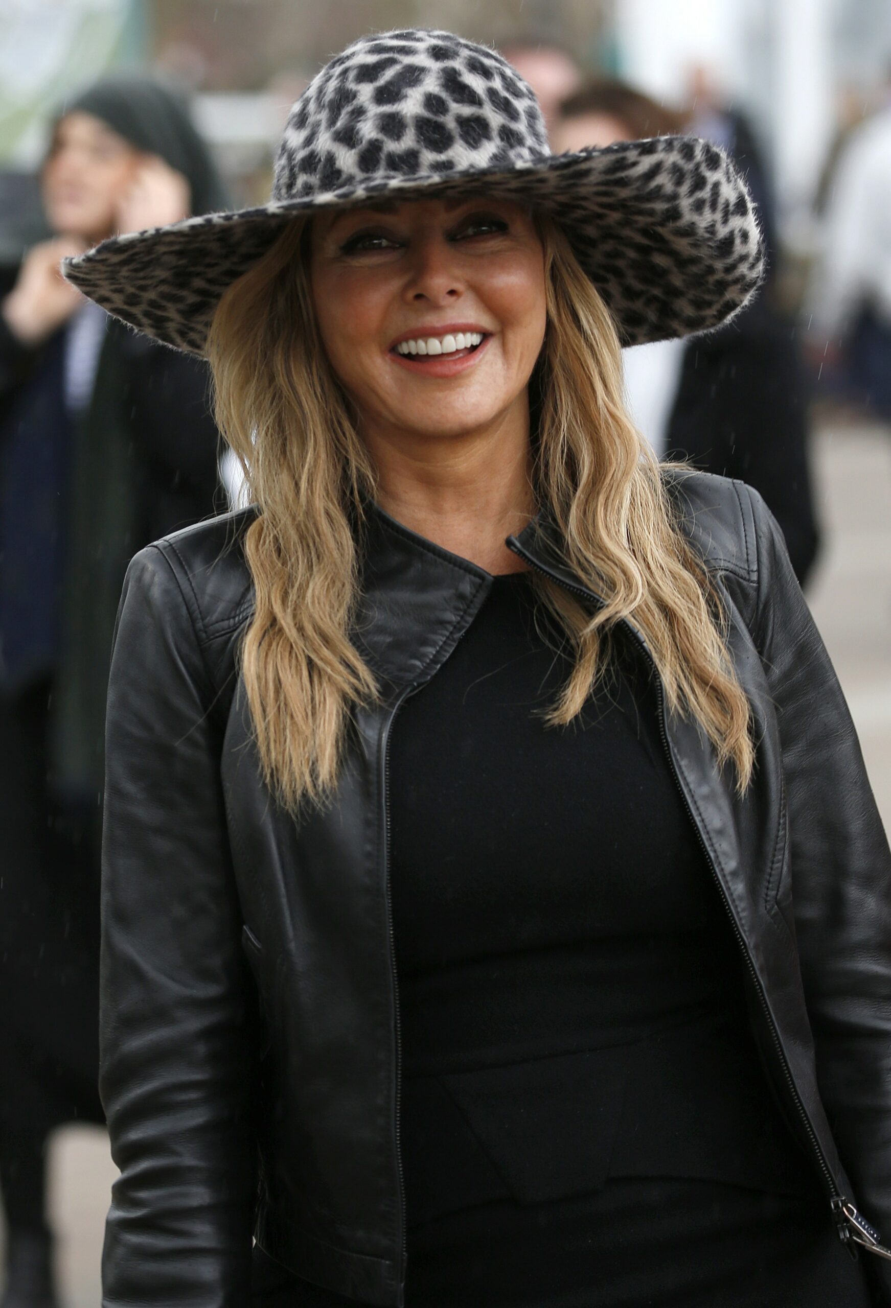 Carol Vorderman in animal print hat at races