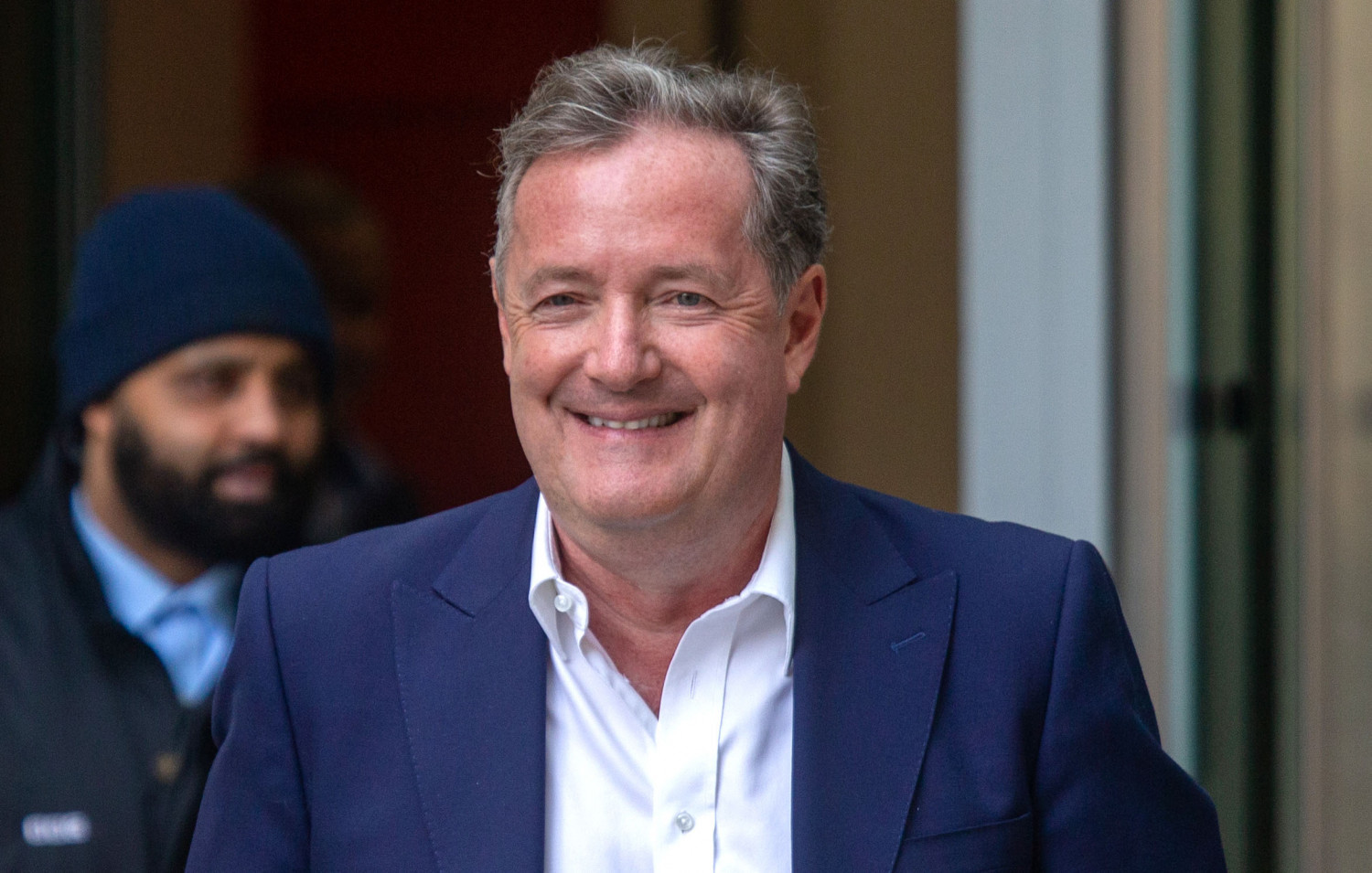 Piers Morgan leaving BBC HQ in blue suit