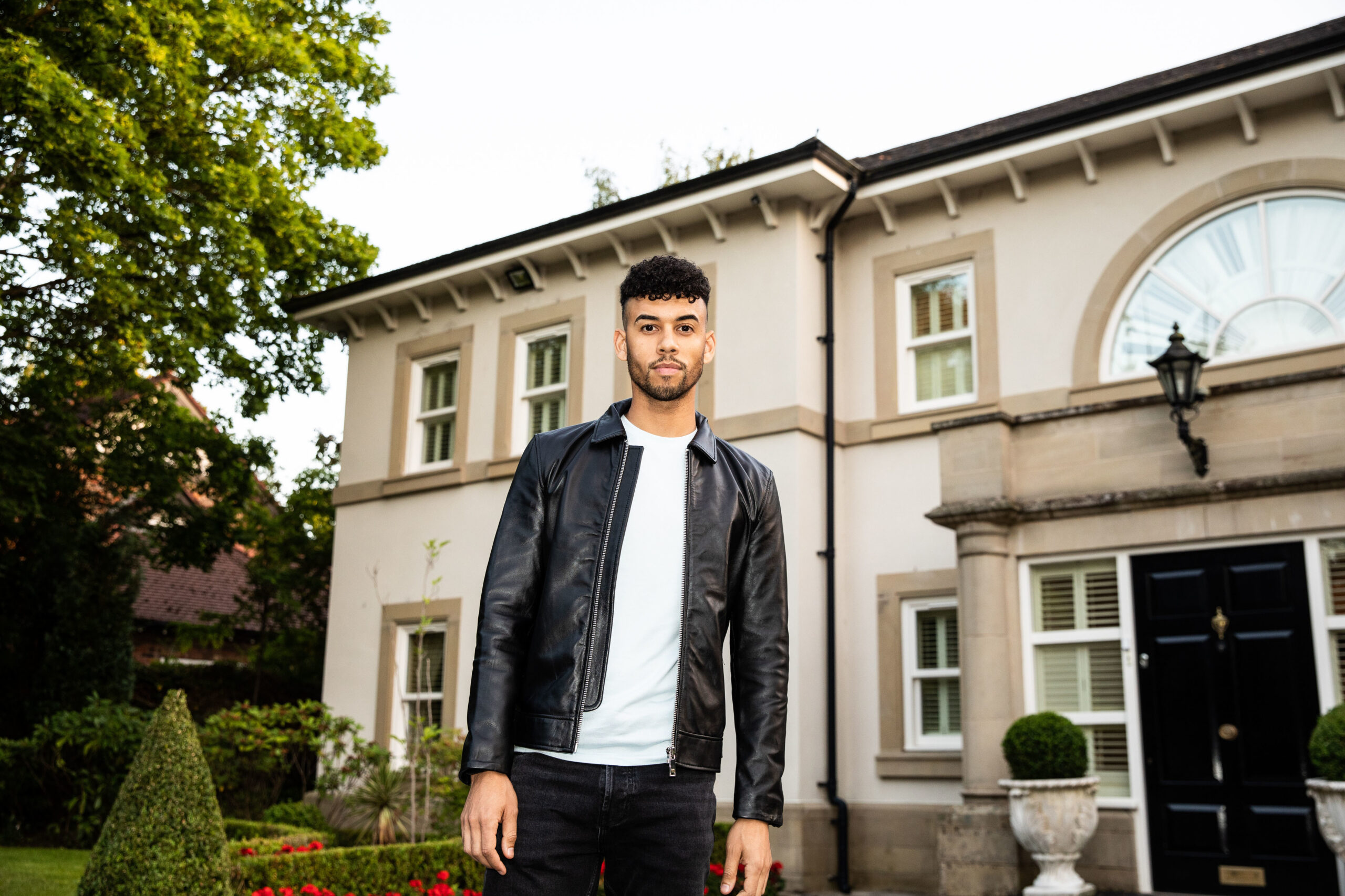 Christopher Jeffers standing outside a beautiful house